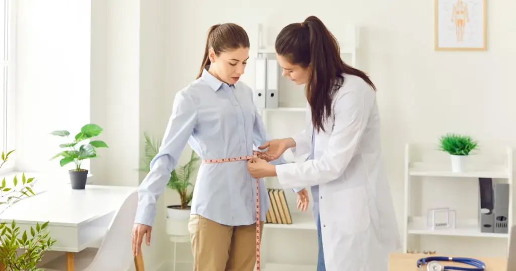 Measuring woman’s waist during Medical Weight Loss in Yuma, AZ